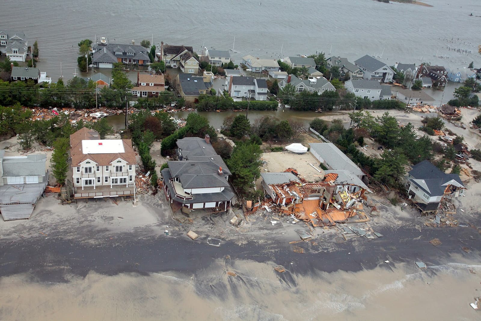 Aerial view of elevated oceanfront homes on the Ocean County, New Jersey barrier island with bay and ocean flood zones visible