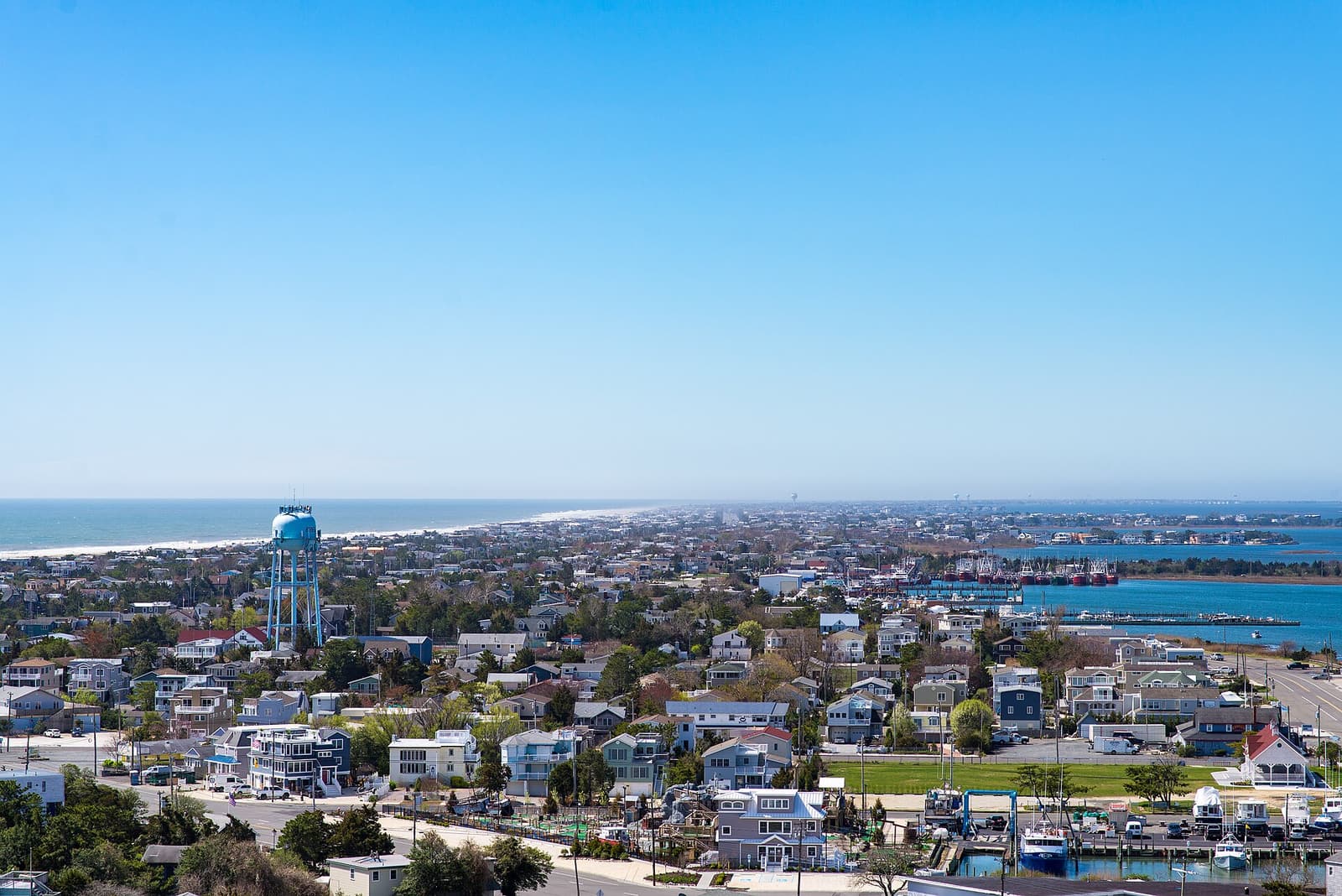 Aerial view of Long Beach Island, NJ, an 18-mile barrier island with oceanfront luxury homes lining the beach and bay